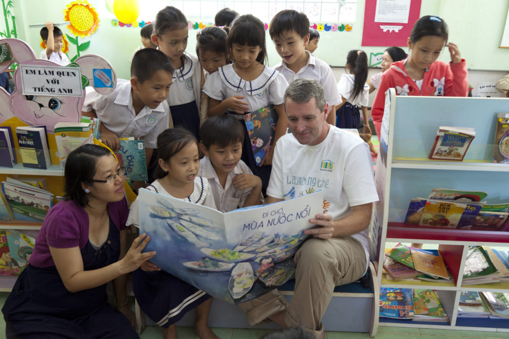 John reading to children at a Room to Read School in Vietnam