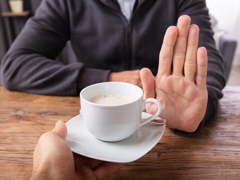 mans-hand-refusing-cup-coffee
