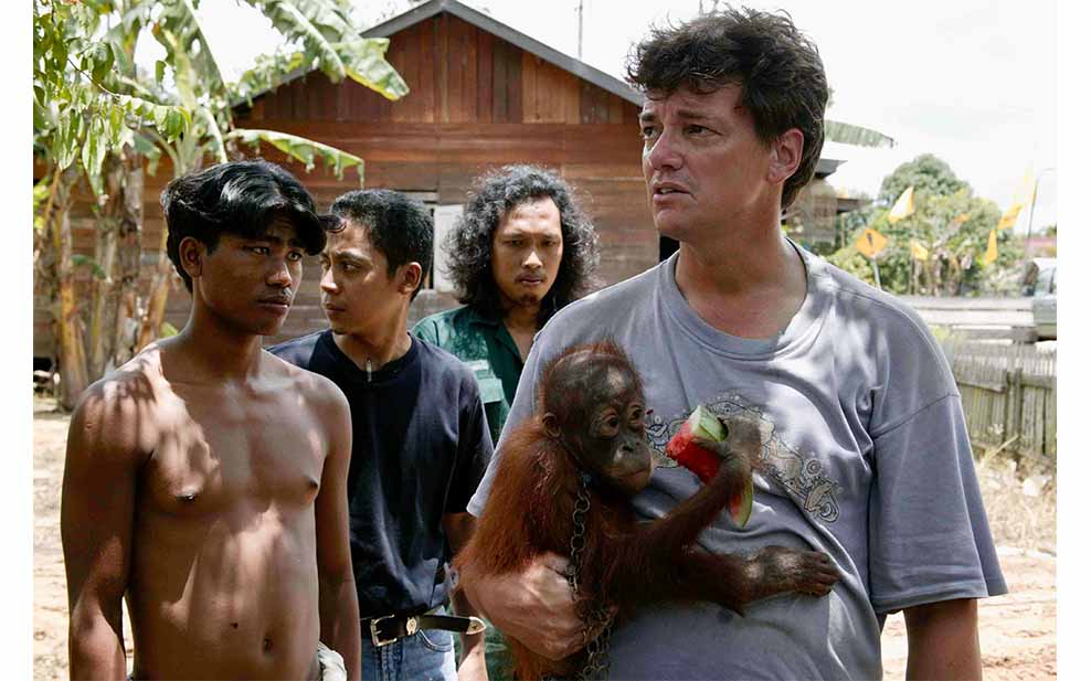 Men with baby orangutan