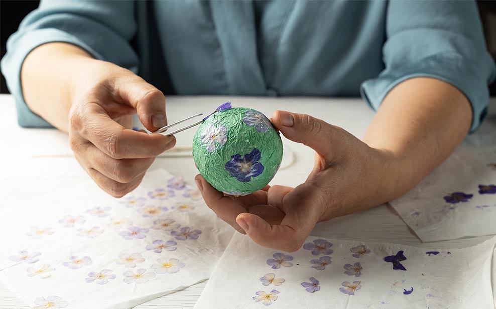 Making a bauble out of papier mâché.